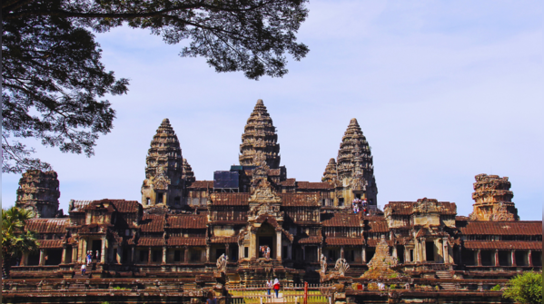 Angkor Wat reflecting the sunrise in its surrounding moat.
