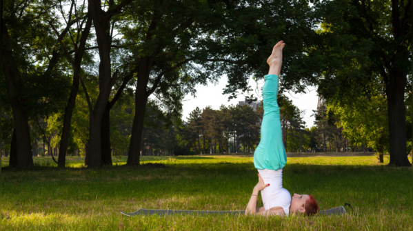 Individual performing Sarvangasana, or Shoulder Stand.