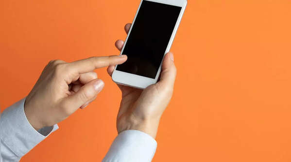 Holding phone with one hand and using the index finger of the other