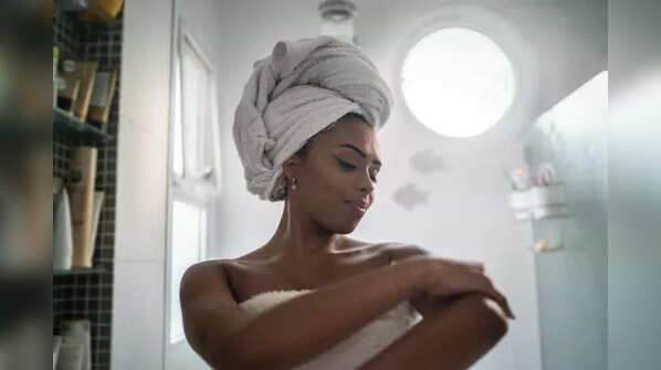 Warm damp towel after hair oiling